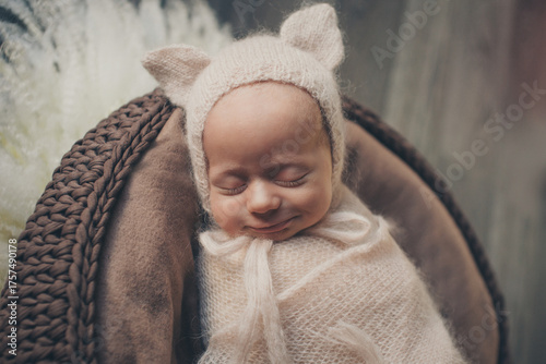 A newborn baby is wrapped in diapers with a wool cap in a basket. Swaddling, maternity hospital, family, ivf, life planning, parenting. A mother's love for her child. Baby food. High quality photo