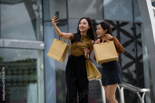 Asian friends shopping taking selfie with bags and credit card