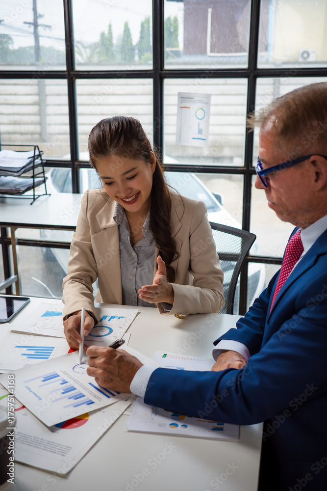 Fototapeta premium Colleagues collaborating on business data analysis in office meeting