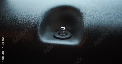 Extreme close-up of a car door lock pin, focus on automotive security, detail, and modern vehicle interior.