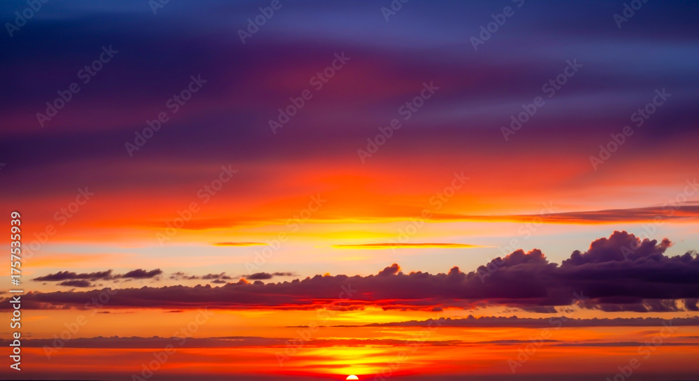 Fototapeta premium Dramatic colorful sunset sky with clouds in orange, purple and blue