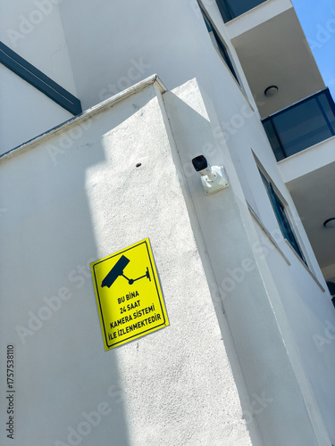 Obraz na plátně Security Camera And Warning Sign On Modern Building Wall Outdoors, Concept Of Sa