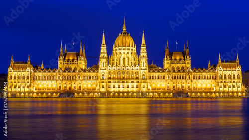 Parliament building illuminated at night over the Danube