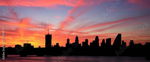 Iconic London skyline silhouette at sunset, dark against vibrant sky, night, view