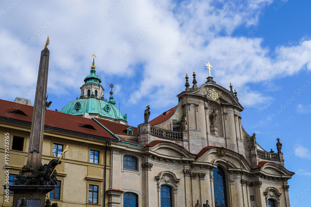 Fototapeta premium Beautiful aerial view St. Nicholas Church in the Lesser Town of Prague, Czech Republic — stunning baroque masterpiece surrounded by colorful old buildings and cobblestone streets