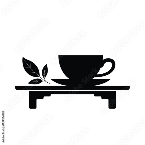 Black silhouette of a tea cup and saucer with a tea leaf sprig
