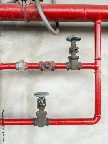 Fire Protection Valves on Red Steel Pipes in Subway Station.