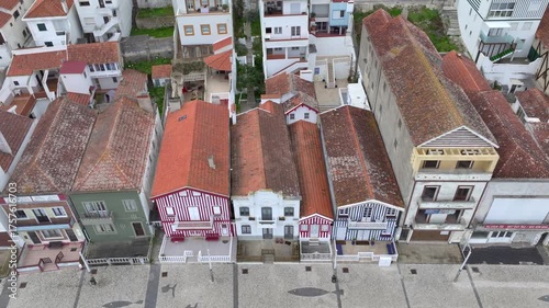 Aerial drone sideways panning of colourful houses along Costa Nova do Prado beach, Portugal