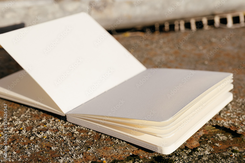 Fototapeta premium Blank white paper notebook on rusty metal background. Copy space.