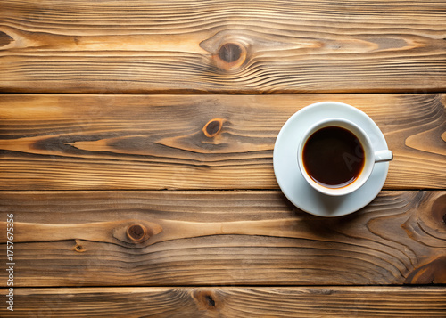 Top view of a cup of coffee on a wooden table, perfect for a cozy morning break