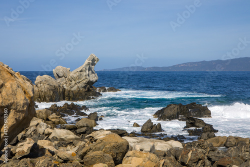 the bizarre granite weathering formations called tafoni with the rugged coastline of Campomoro in sunshine and blue skies