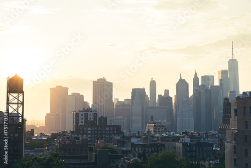 View of financial district Manhattan skyline and Brooklyn buildings at sunset
