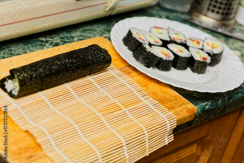 Homemade Maki Sushi Rolls on Green Countertop Ready to Serve