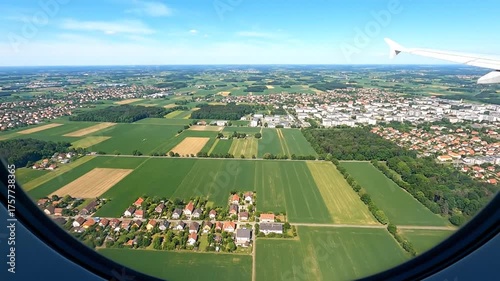 Aerial view of landscape from airplane window on sunny day