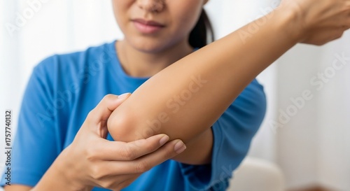 Tennis elbow. The girl grabbed her elbow from the sharp pain. Sports injury.