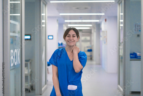 Free Download Smiling female nurse working in hospital corridor healthcare - GFXLoad