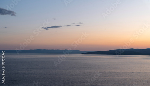 Sunset sea with headland and boat