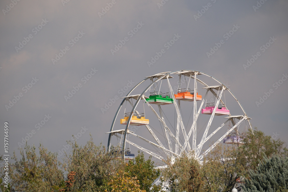 Fototapeta premium Section of a colorful ferris wheel in the amusement park.
