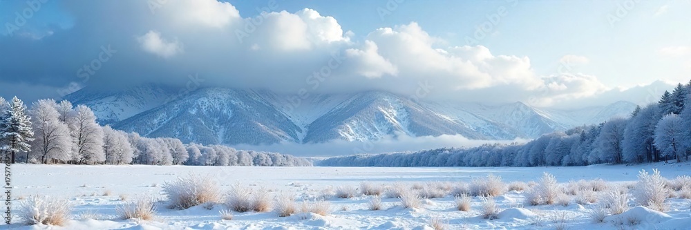 Fototapeta premium Dramatic Low-Hanging Clouds Over Snow-Covered Winter Landscape, Majestic Mountains in Background - Serene Winter Scene