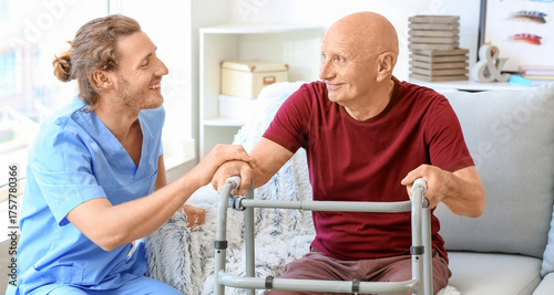 Elderly man with caregiver ...