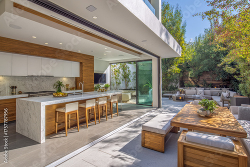 Luxurious open-plan kitchen merges with outdoor dining patio through large glass doors. A perfect blend of modern architecture, nature, and comfort with cinematic lighting and detail.