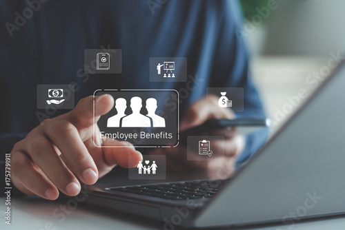 Quadro su tela Businessman using laptop and smartphone with employee benefits icons, representing HR management, staff welfare and compensation