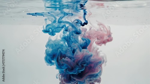 Ink clouds blue and pink swirling in water