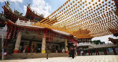 Kuala Lumpur, Malaysia – October 13, 2025: Time lapse of Thean Hou Temple courtyard decorated with hundreds of lanterns, visitors walking and clouds moving above