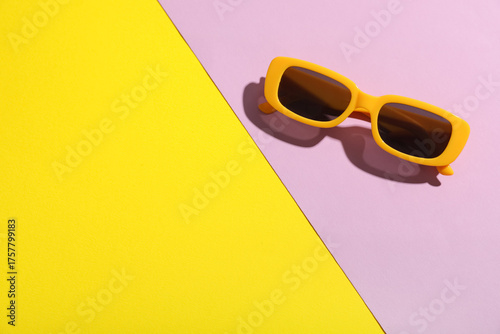 Stylish sunglasses on color...