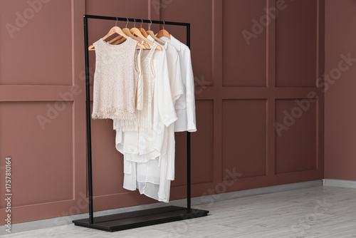 Rack with stylish clothes n...