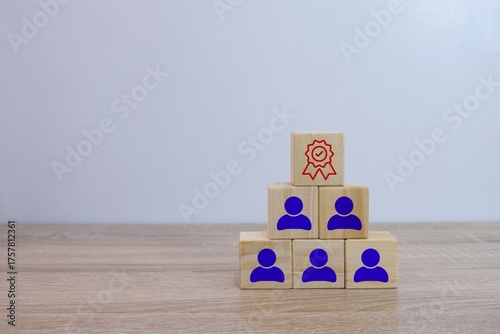 Conceptual pyramid of wooden blocks representing employee recognition and achievement