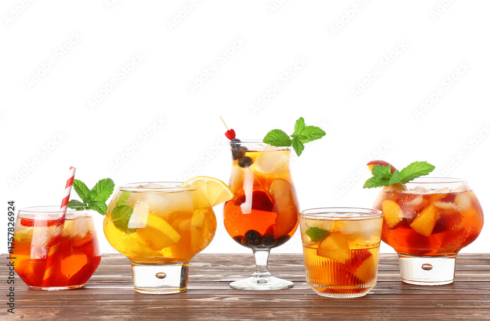 Fototapeta premium Glass of cold tea with different fruit slices, berries and mint leaves on white background