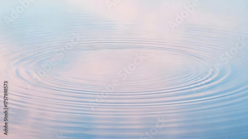 Ripples forming on the tranquil surface of calm water. Soft pastel colors create a sense of peace and serenity.