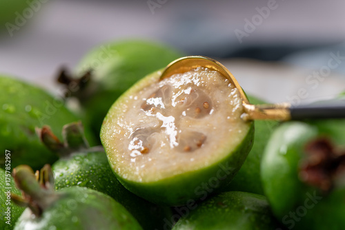 Ultra-close-up of a golden spoon in a feijoa
