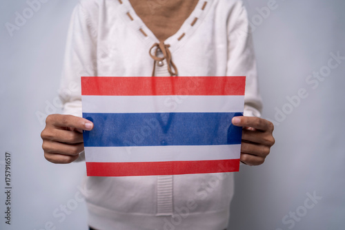 Person Holding the Flag of Thailand with Pride
