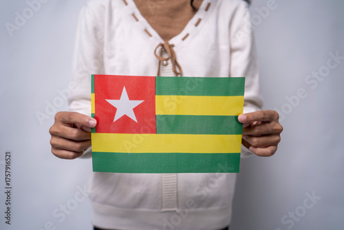 Person Holding the Flag of Togo with Pride