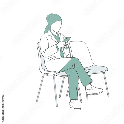 Healthcare professional wearing hijab and lab coat sits in waiting room, looking at her phone