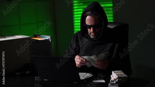 Hacker attack. Technology cybercrime. Hooded hacker online security. Hacking expert. Hacking and malware concept. Hacker steal money in the office. Cyber attack with hooded hacker counting money