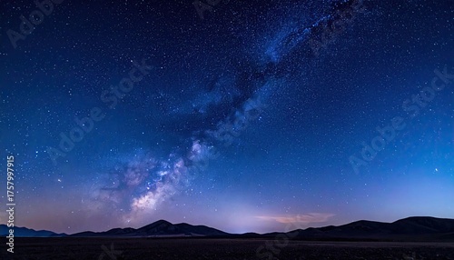 Vast Starry Night Sky Over Distant Hills with the Milky Way Galaxy Illuminated in Deep Blue and Purple Hues