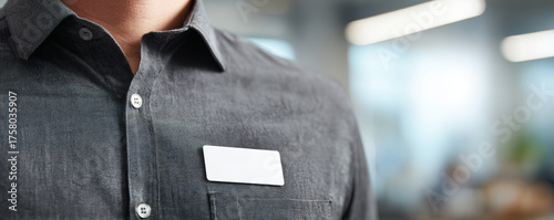 Name tag on chest grey shirt employee uniform professional office environment welcoming badge