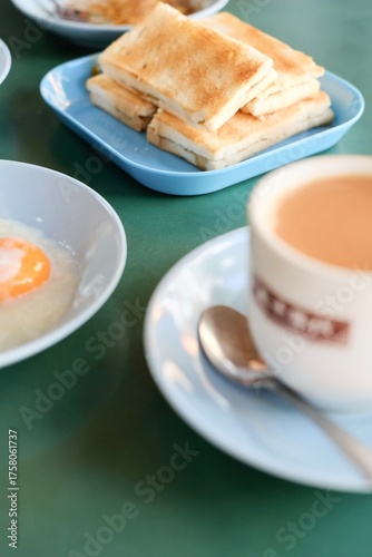 A cup of teh-c kosong (tea with evaporated milk, no sugar), half-boiled eggs with soy sauce and traditional kaya toast at The 1950s Coffee, a hawker stall at Maxwell Food Centre in Singapore