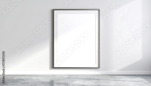 A modern, minimalist room setting with a blank framed poster, showcasing a clean and bright interior design.
