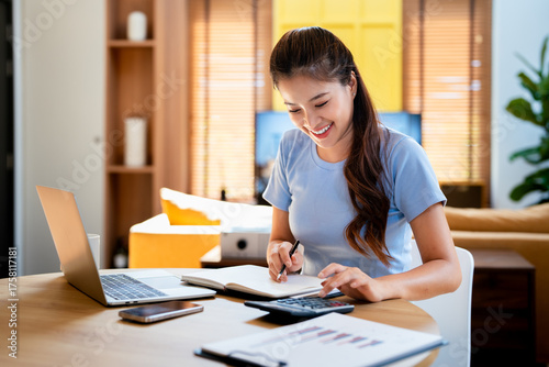 Deduction planning, debt asian young woman  hand using calculator to calculating  money balance from bill and income, cost budget expenses for pay money form personal individual on table at home.
