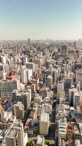 Canvas Print Breathtaking drone shot over Tokyo showing dense skyline, streets, and iconic bu