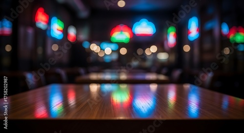Vibrant bokeh lights reflecting on a wooden table in a dimly lit room