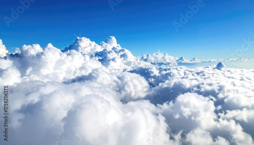 Fotografie Vast Expanse of Fluffy White Cumulus Clouds Under a Bright Blue Sky seen from Ab
