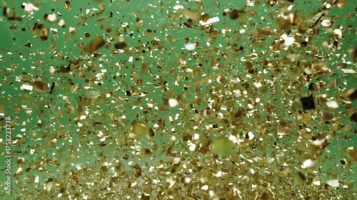Floating gold foil confetti against a bright green background