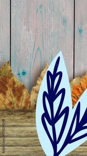 Animation of leaves and leaf drawing on wooden background