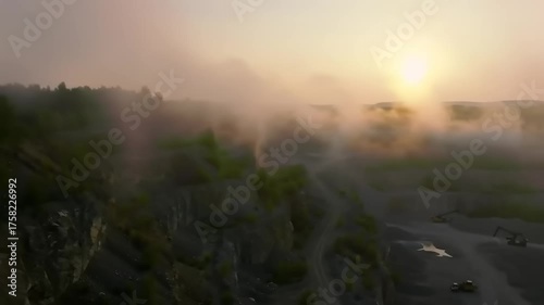 Sunrise over a foggy landscape with trees and aerial perspective