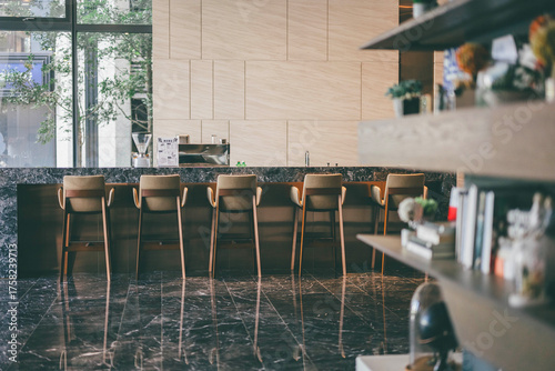 Modern cafe interior with marble counter and wooden chairs in natural light
